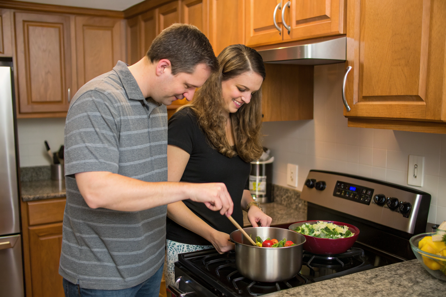 Man and woman mid thirties cooking in a kitchen together
